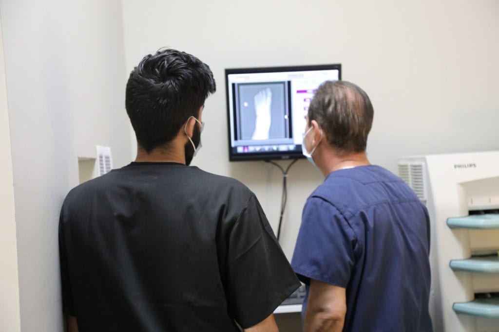 Doctors reviewing an X-ray on screen