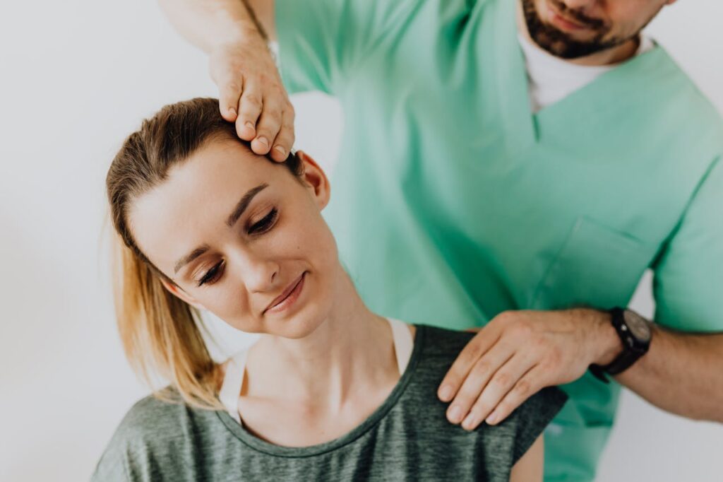 Chiropractor adjusting a patient’s neck