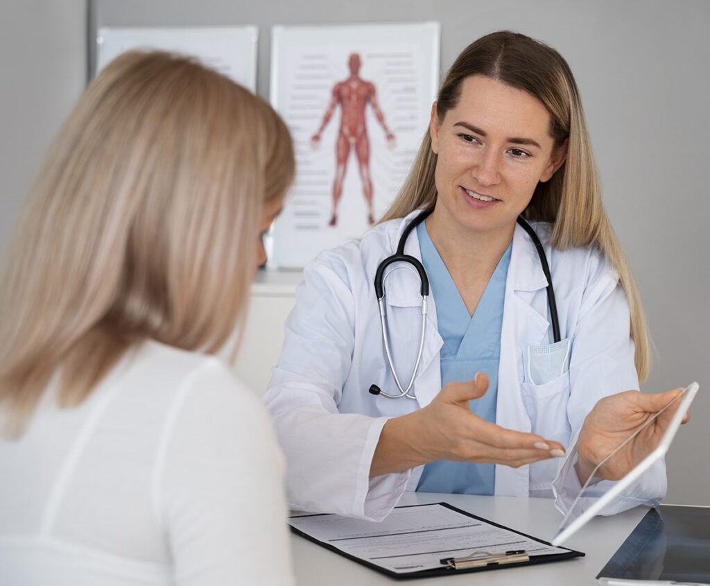 Chiropractor reviewing an ankle injury diagnosis with a patient